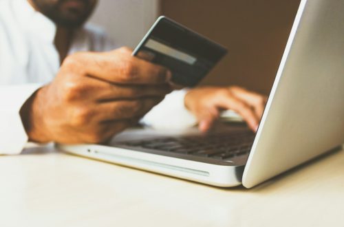 Credit card beside laptop for online payment security