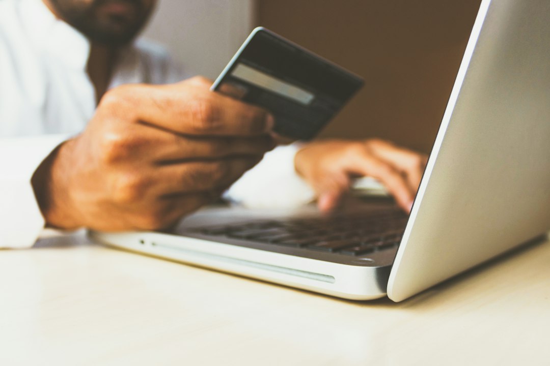 Credit card beside laptop for online payment security