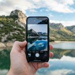 Person using a smartphone camera for AI photo editing