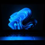 Laptop displaying a Windows-style desktop in a workspace